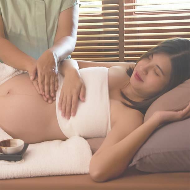 The therapiist massaging pregnant woman,for treat and relax program,at spa therapy